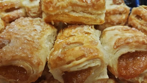 A tray of golden apple hand pies.