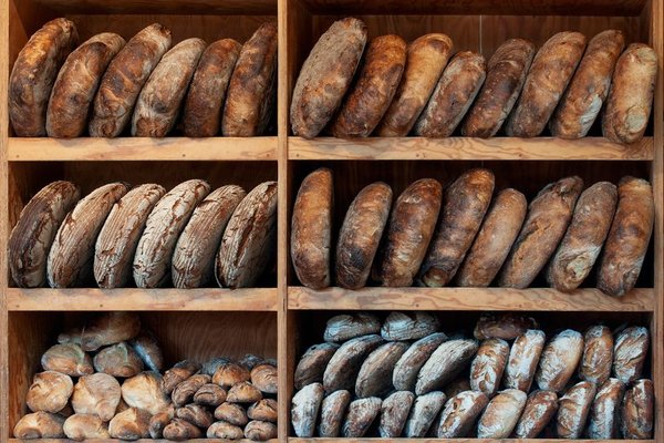 Shelves stacked with dark-crusted loaves for the wholesale run.
